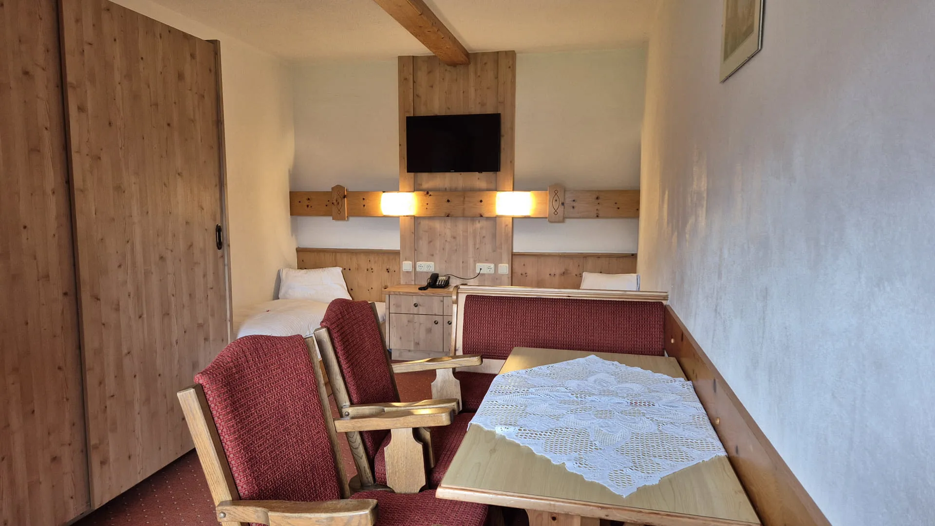 4-Bettzimmer mit Holzdetails und gemütlichem Mobiliar